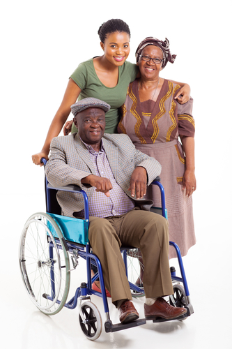 Women helping man in wheelchair.